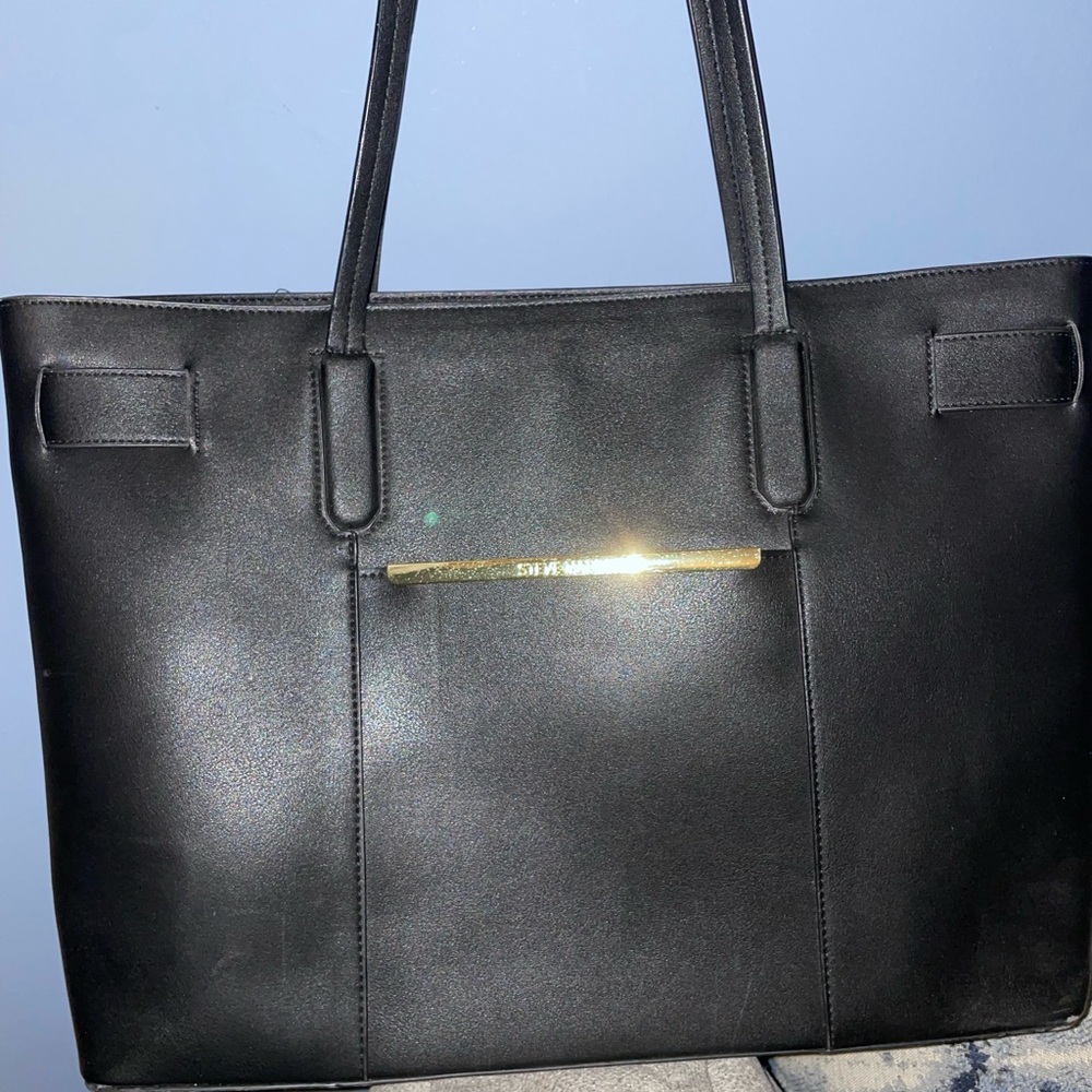 Womans black Steve Madden purse with multiple compartments can fit a laptop